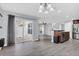 An open living space with gray flooring, leading to a fenced patio and adjoining the kitchen area at 13118 Honey Locust Dr, Orlando, FL 32828