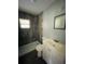 Modern bathroom with tiled walk-in shower, white vanity, and contemporary fixtures, offering a clean and updated space at 1312 Simmons Rd, Kissimmee, FL 34744