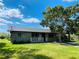 Charming single-story home with a well-manicured lawn, inviting front porch, and covered parking at 1312 Simmons Rd, Kissimmee, FL 34744