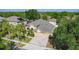 Aerial view of a spacious home with manicured landscaping, a paver driveway, and a three-car garage at 13139 Paloma Dr, Orlando, FL 32837
