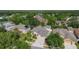 Overhead view of a well-kept home featuring mature trees, manicured landscaping and a three-car garage at 13139 Paloma Dr, Orlando, FL 32837