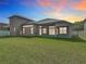 Expansive backyard featuring lush green grass and a covered patio, perfect for outdoor living and entertaining at 13139 Paloma Dr, Orlando, FL 32837
