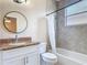 Bathroom features a granite vanity, updated mirror, tiled shower, and tub with shower curtain at 13139 Paloma Dr, Orlando, FL 32837