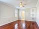 Bright bedroom with hardwood floors, ceiling fan, and access to the bathroom at 13139 Paloma Dr, Orlando, FL 32837