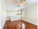 A bonus room features hardwood floors, neutral paint, a ceiling fan, and windows with natural light at 13139 Paloma Dr, Orlando, FL 32837
