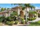 Beautiful home exterior with lush tropical landscaping, manicured shrubs, and a well-maintained lawn at 13139 Paloma Dr, Orlando, FL 32837