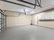 Spacious garage with epoxy floors and cabinets for storage, offers ample room for vehicles and projects at 13139 Paloma Dr, Orlando, FL 32837