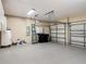 An expansive garage with epoxy flooring, ample storage space, and two doors for multiple vehicles at 13139 Paloma Dr, Orlando, FL 32837