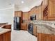 Beautiful kitchen featuring custom wood cabinets, granite countertops, and stainless steel appliances at 13139 Paloma Dr, Orlando, FL 32837