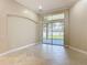 Neutral living room with tile flooring, a transom window, and sliding glass doors for seamless indoor-outdoor living at 13139 Paloma Dr, Orlando, FL 32837