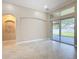 A bright living room features tile flooring, large windows, and sliding glass doors to the backyard at 13139 Paloma Dr, Orlando, FL 32837