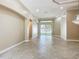 Open-concept living room featuring tile floors, neutral walls, and sliding glass doors leading to the backyard at 13139 Paloma Dr, Orlando, FL 32837