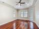 This main bedroom features hardwood floors, a ceiling fan, and natural light from two large windows at 13139 Paloma Dr, Orlando, FL 32837