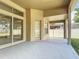 View of the covered patio with access to the backyard with manicured lawn and privacy fence at 13139 Paloma Dr, Orlando, FL 32837