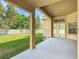 Covered outdoor patio offering a view of the well-maintained backyard and a white picket fence at 13139 Paloma Dr, Orlando, FL 32837