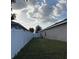 Backyard view showing the privacy fence and green space at 1381 Woodlark Dr, Haines City, FL 33844