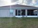 Home featuring a cozy lanai in a spacious backyard, perfect for outdoor enjoyment at 1381 Woodlark Dr, Haines City, FL 33844