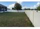 Spacious backyard featuring a white vinyl fence and a mature tree at 1381 Woodlark Dr, Haines City, FL 33844