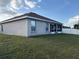 View of the backyard featuring a screened in patio and privacy fence at 1381 Woodlark Dr, Haines City, FL 33844