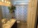 Bright bathroom featuring a double vanity and shower with decorative curtain, ready for relaxation at 1381 Woodlark Dr, Haines City, FL 33844