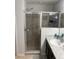 Bathroom featuring a shower with glass doors, granite countertop vanity, sink, and neutral color palette at 1381 Woodlark Dr, Haines City, FL 33844