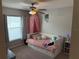 Bedroom featuring natural light, pink accents, a daybed with storage drawers, and a ceiling fan at 1381 Woodlark Dr, Haines City, FL 33844