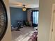 Bedroom area featuring neutral carpet, a ceiling fan and window, suitable for a home gym or playroom at 1381 Woodlark Dr, Haines City, FL 33844