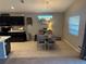 Open view of the dining area, connected to the kitchen and featuring warm light and decor at 1381 Woodlark Dr, Haines City, FL 33844