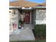 Inviting front entrance with decorative accents and a well manicured landscape at 1381 Woodlark Dr, Haines City, FL 33844