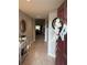 Warm foyer with a decorative console table, mirror and views into the home's living area at 1381 Woodlark Dr, Haines City, FL 33844