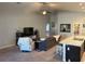 Cozy living room with ceiling fan, neutral color walls, plush seating, and an adjacent kitchen area at 1381 Woodlark Dr, Haines City, FL 33844