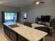 Bright living space with a ceiling fan, comfortable seating and sliding glass door to outdoor area at 1381 Woodlark Dr, Haines City, FL 33844
