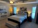 Bright main bedroom with natural light, bedside tables, stylish decor, and a comfortable bed at 1381 Woodlark Dr, Haines City, FL 33844