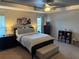 Comfortable main bedroom with a ceiling fan, bedside tables, lamps, and natural light from the window at 1381 Woodlark Dr, Haines City, FL 33844