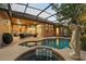 Beautiful pool with lush landscaping and a screened enclosure and covered lanai at 1544 Hunters Mill Pl, Oviedo, FL 32765