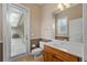Bathroom with half-painted walls, white vanity, a toilet, and access to the exterior at 1544 Hunters Mill Pl, Oviedo, FL 32765