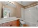 Bright bathroom features a vanity with a large mirror and a shower-tub combination at 1544 Hunters Mill Pl, Oviedo, FL 32765
