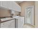 Clean laundry room with sink, washer, dryer, and storage at 1544 Hunters Mill Pl, Oviedo, FL 32765