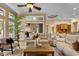 Open concept living room has a large sectional sofa and oversized plant at 1544 Hunters Mill Pl, Oviedo, FL 32765