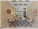 Elegant living room with high ceilings, a geometric coffered ceiling, and stylish decor at 1544 Hunters Mill Pl, Oviedo, FL 32765