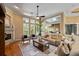 Bright living room with hardwood floors, fireplace, and large windows providing natural light at 1544 Hunters Mill Pl, Oviedo, FL 32765