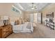 Spacious main bedroom with tray ceilings, neutral carpet and adjoining bath at 1544 Hunters Mill Pl, Oviedo, FL 32765