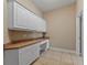 Office area features built-in cabinets, drawers and plenty of countertop space at 1544 Hunters Mill Pl, Oviedo, FL 32765