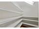 Walk-in pantry with bright white shelving for storing all your items at 1544 Hunters Mill Pl, Oviedo, FL 32765