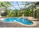 Sparkling pool and spa surrounded by lush tropical landscaping and a screened enclosure at 1544 Hunters Mill Pl, Oviedo, FL 32765