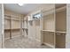 Spacious walk-in closet with built in white shelving and carpet floors at 1544 Hunters Mill Pl, Oviedo, FL 32765