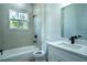 Modern bathroom featuring a shower-tub, quartz countertop vanity, and black fixtures at 160 Fisher Loop, Ocklawaha, FL 32179