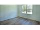 Bright bedroom featuring wood-look flooring and a window with natural light at 160 Fisher Loop, Ocklawaha, FL 32179
