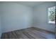 Cozy bedroom with wood-look floors and a window providing natural light at 160 Fisher Loop, Ocklawaha, FL 32179