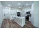 Bright kitchen featuring white cabinets, stainless steel appliances, and a center island at 160 Fisher Loop, Ocklawaha, FL 32179
